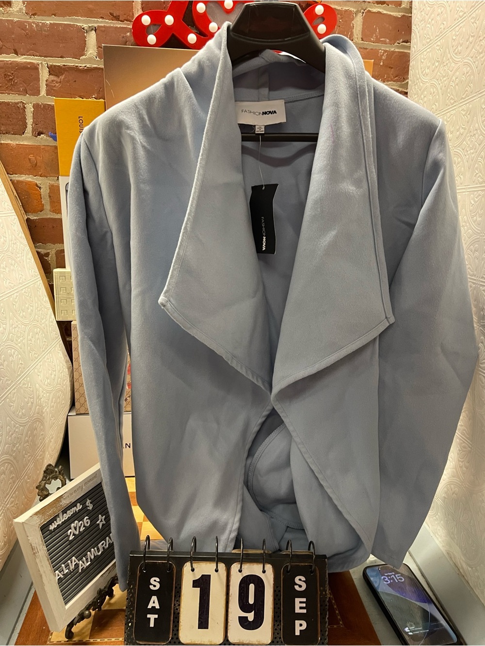 light blue open-front draped jacket from Fashion Nova featuring a soft, cascadin
